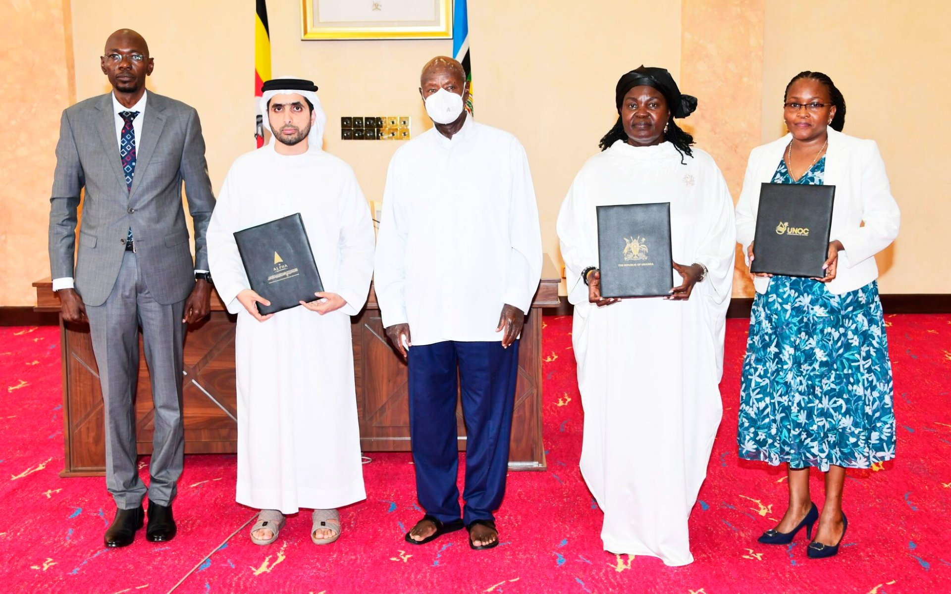 Group of officials standing together during the signing ceremony for Uganda oil refinery investment partnership with a UAE delegation.