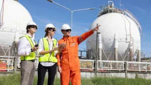 A team of specialized engineers and technical contractors inspecting a spherical storage facility, highlighting the precision required in oil and gas contractor management in Nigeria for offshore and onshore projects.