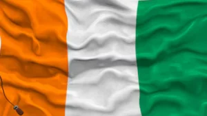 The flag of Côte d'Ivoire waving, symbolizing the regional market entry opportunities available to businesses who confirm that, yes, Can an EOR sponsor work permits in Ivory Coast? to legally mobilize their technical teams.