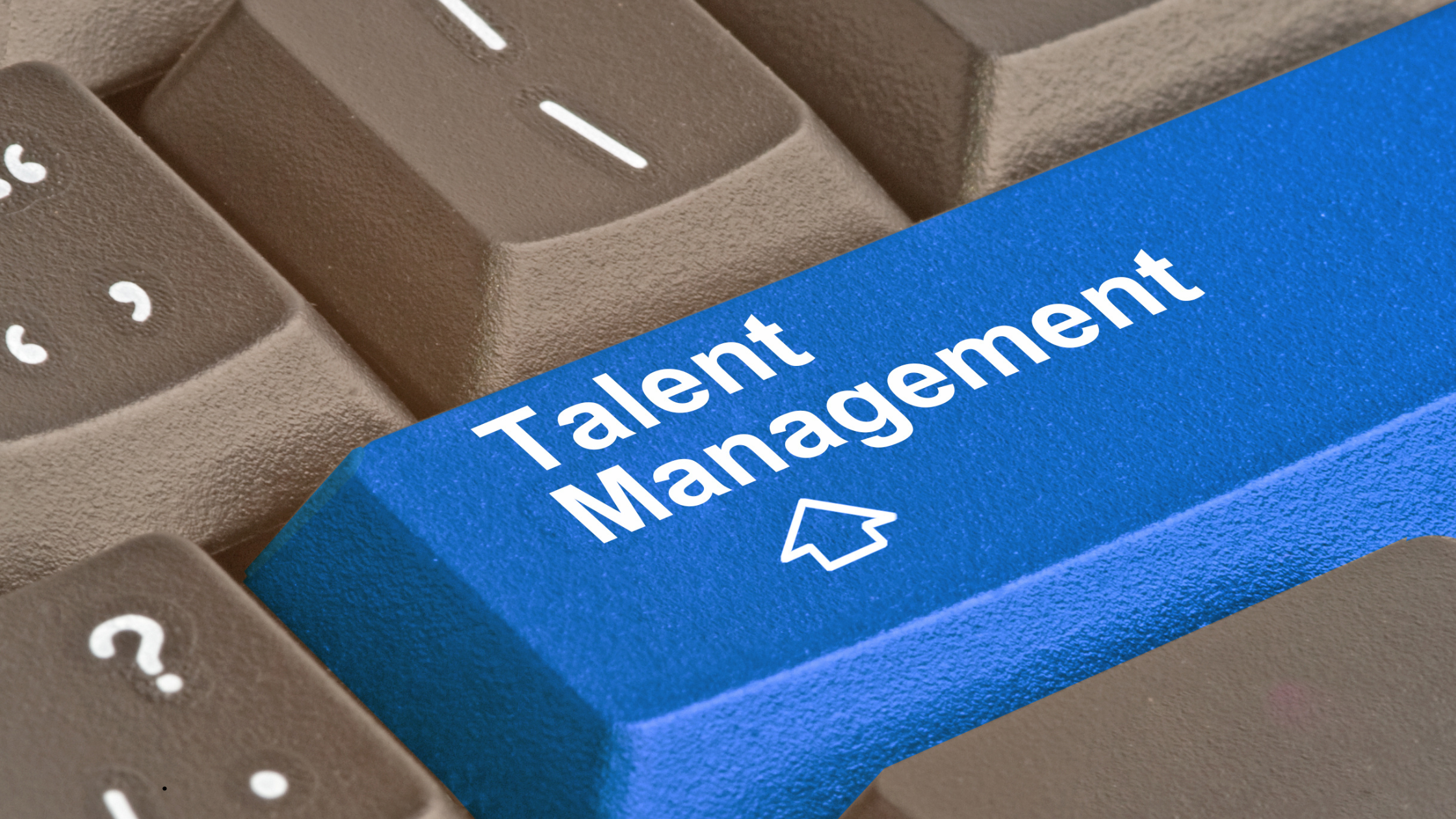 Talent Management concept displayed on a computer keyboard, representing strategic talent management services for workforce planning, employee development, recruitment, and retention in modern organizations.