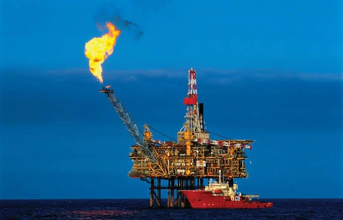 "Yoho platform restart — offshore oil rig flaring gas at dusk in Nigerian waters